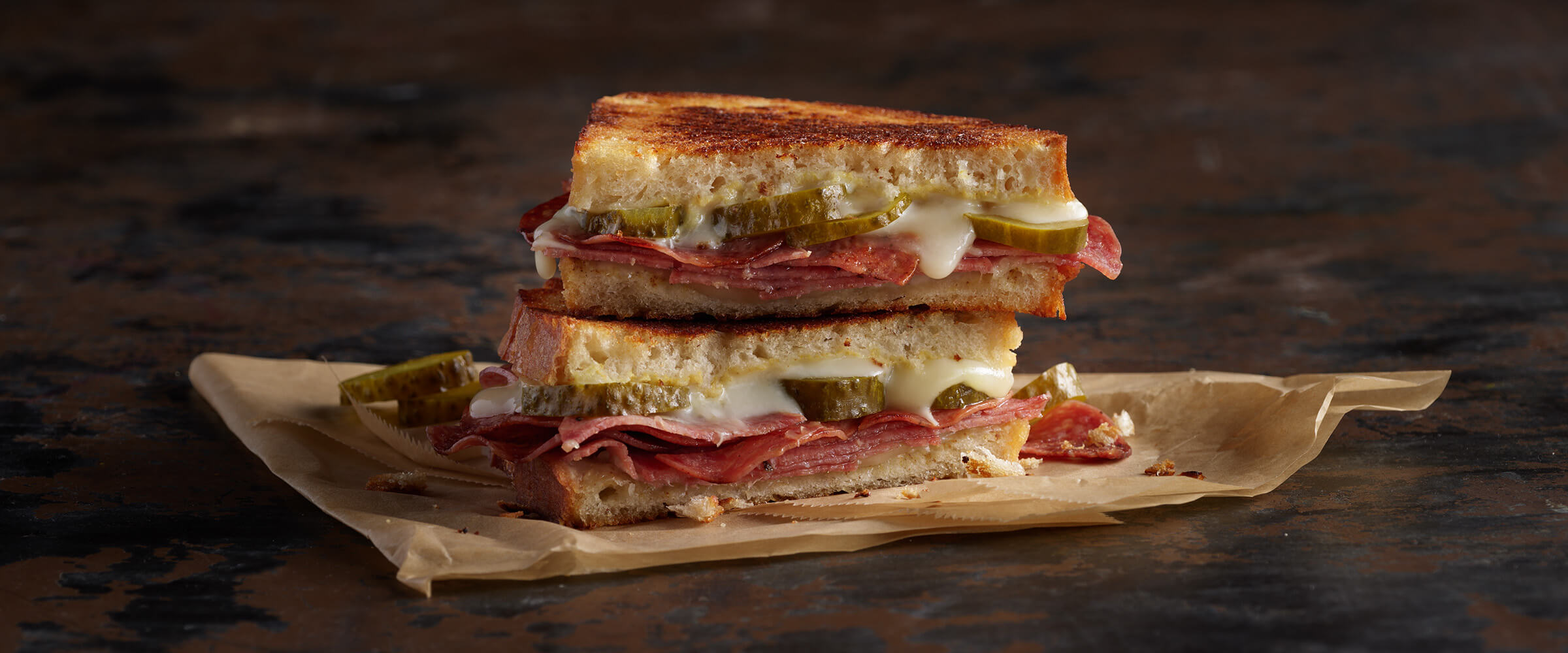 https://www.hormelfoods.com/wp-content/uploads/COLUMBUS_italian_dry_salami_pickle_grill_cheese-2400x1000-1.jpg