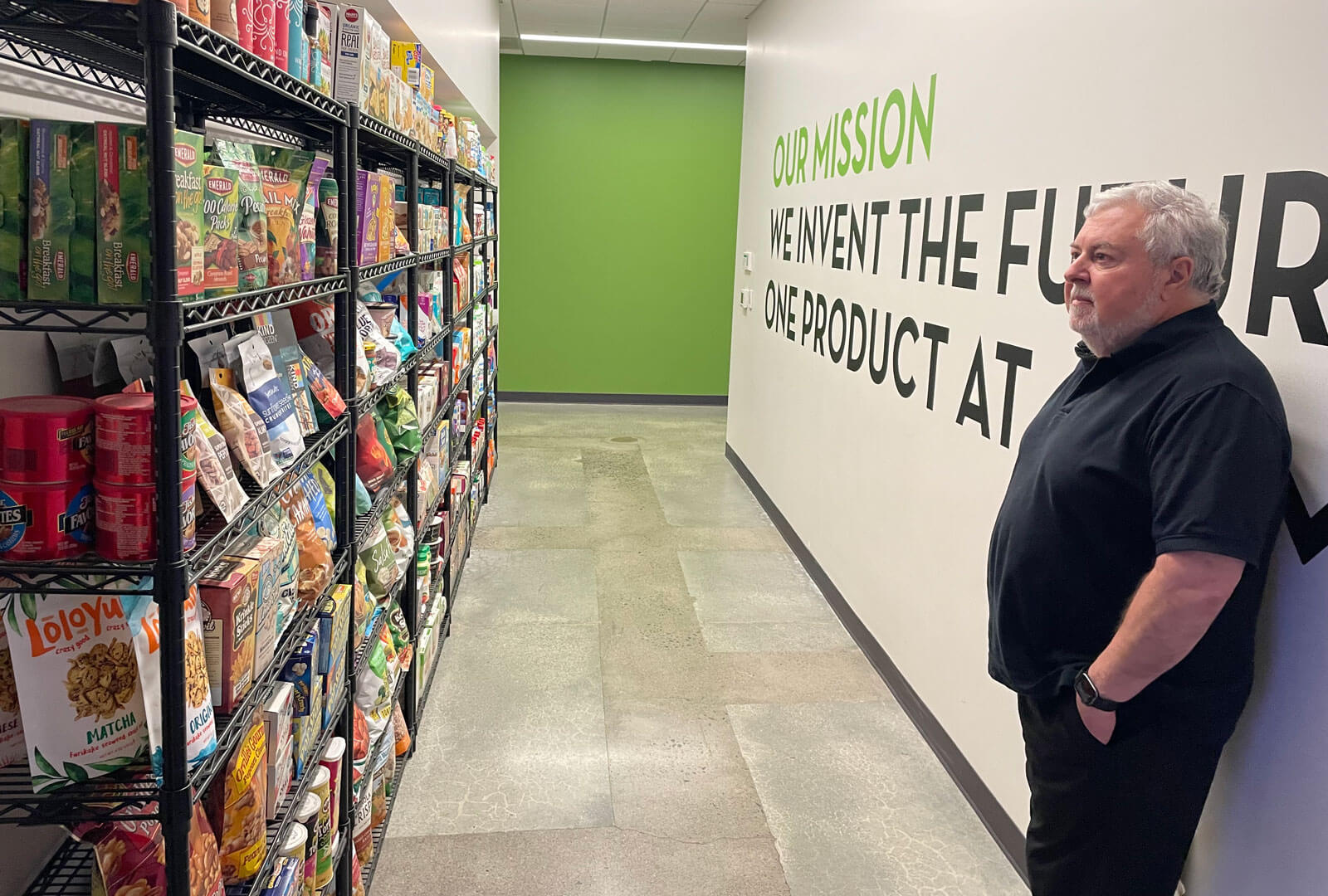 Steve Gundrum standing and looking at some shelves full of food
